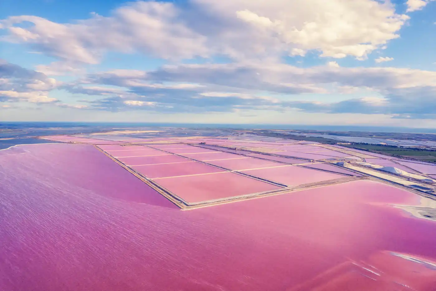 An aerial view of the pink salt pans of the Salins du Midi beside Aigues-Mortes